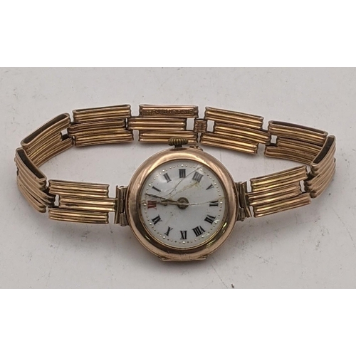 82 - A 9ct gold ladies manual wind wrist watch A/F on a 9ct gold expanding bracelet total weight 19.9g
Lo... 