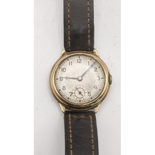 83 - A gents 9ct gold manual wind wrist watch on a brown leather strap 
Location: CAB 4
If there is no co... 