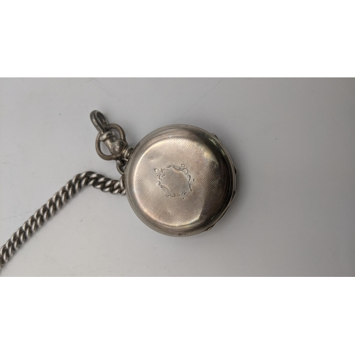 85 - A Victorian open faced ladies pocket watch on a silver pocket watch on a silver pocket watch chain h... 