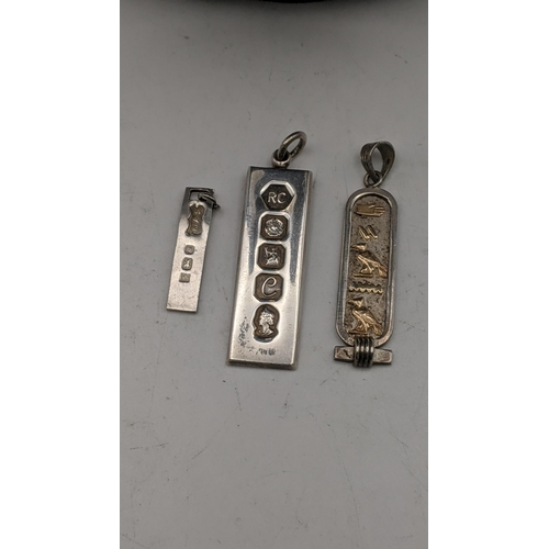 87 - 4 silver ingot pendants two on silver necklaces together with a white metal Egyptian Cartouche total... 