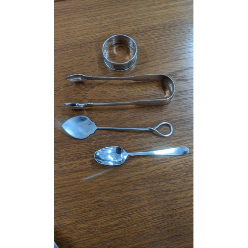 95 - A Georgian silver sugar sifter and teaspoon together with a sugar caster, tea strainer and other sil... 