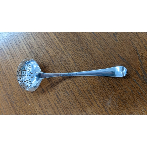 95 - A Georgian silver sugar sifter and teaspoon together with a sugar caster, tea strainer and other sil... 