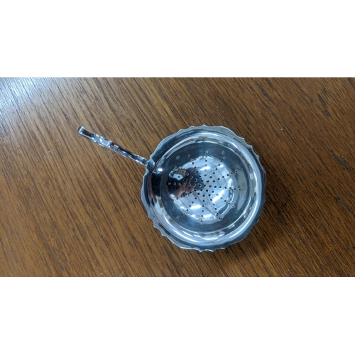 95 - A Georgian silver sugar sifter and teaspoon together with a sugar caster, tea strainer and other sil... 