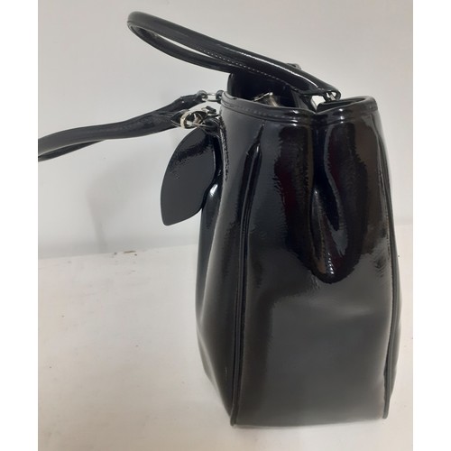 10 - Lulu Guinness- A large black patent handbag 40cm wide x 30cm high having silver tone hardware and re... 