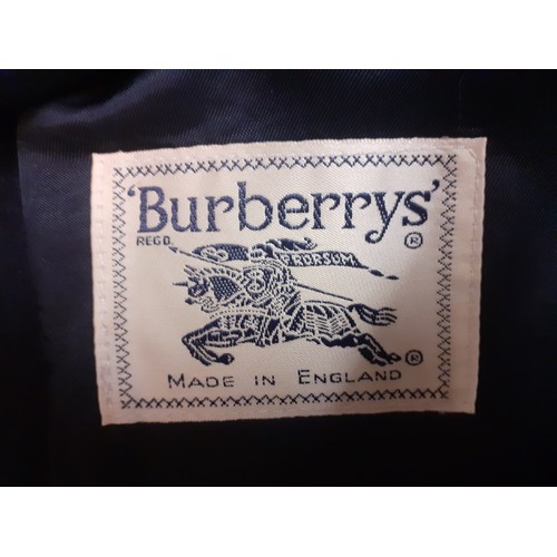 11 - Burberrys- A ladies navy blazer with 2 gold coloured crested buttons to the front and 3 to each cuff... 