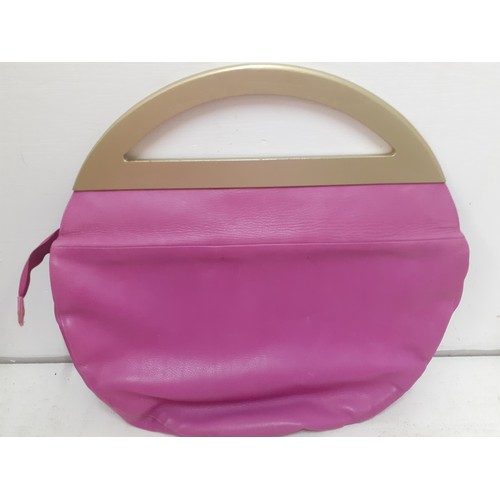 21 - Charles Jourdan- A 1970's hot pink bag with gold painted handle 40cm wide x 30cm high and a pink and... 