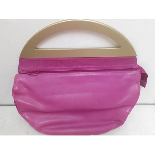 21 - Charles Jourdan- A 1970's hot pink bag with gold painted handle 40cm wide x 30cm high and a pink and... 