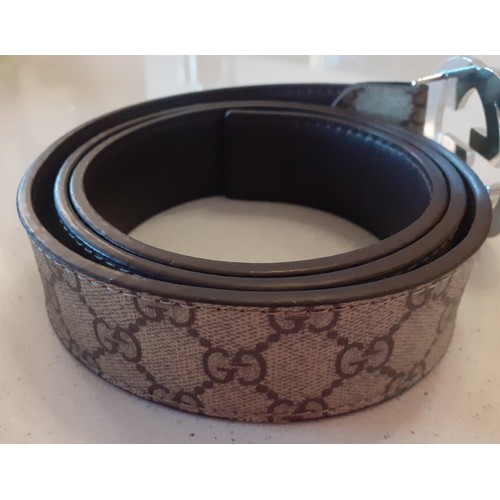 12 - THIS LOT HAS BEEN WITHDRAWN Gucci- A beige 'GG Supreme' monogram belt having a silver tone double G ... 