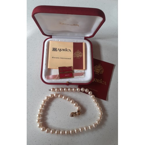 67 - A string of Majorcan pearls with gold tone bow shaped clasp, 43cm in length, each pearl approx 5mm w... 