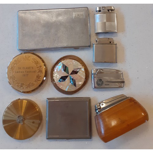 73 - A group of vintage compacts, cigarette cases and lighters to include a 1977 Stratton gold tone compa... 