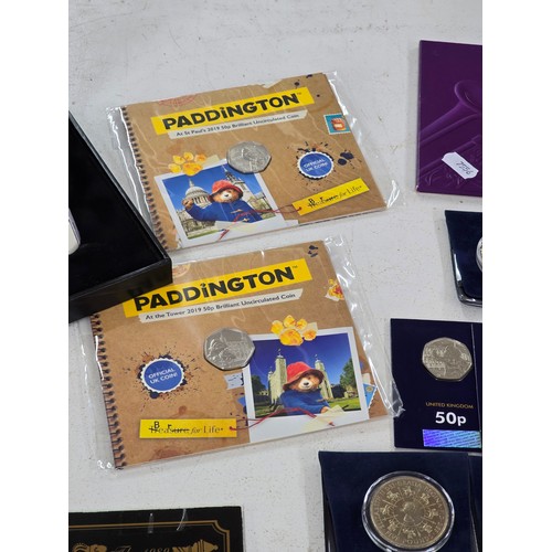 440 - A collection of coin sets to include 2019 Paddington at St Pauls and The Tower presentation packs, 2... 