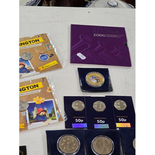 440 - A collection of coin sets to include 2019 Paddington at St Pauls and The Tower presentation packs, 2... 