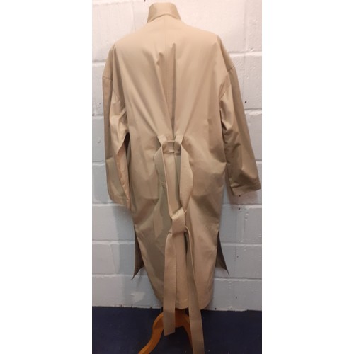 29 - Courreges of Paris-An unused beige 'Manteau' trench coat, approx 46