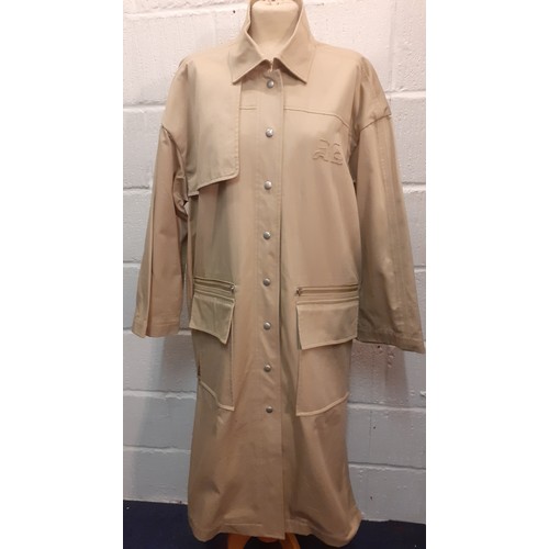 29 - Courreges of Paris-An unused beige 'Manteau' trench coat, approx 46