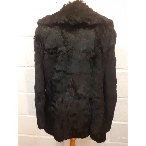 78 - Two fur jackets comprising a late 20th Century black coney soft fur jacket with shawl collar, UK siz... 