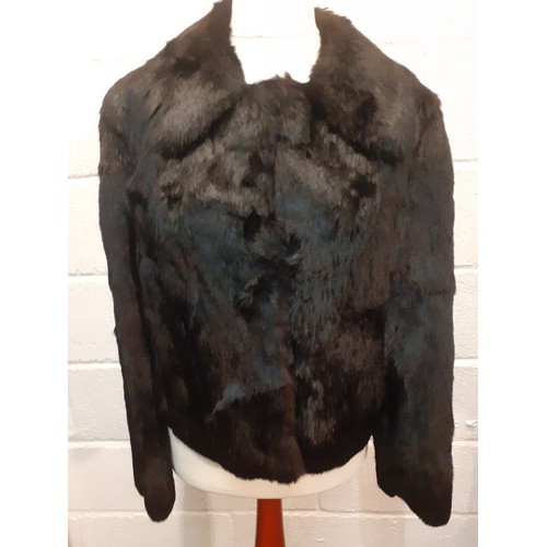 78 - Two fur jackets comprising a late 20th Century black coney soft fur jacket with shawl collar, UK siz... 