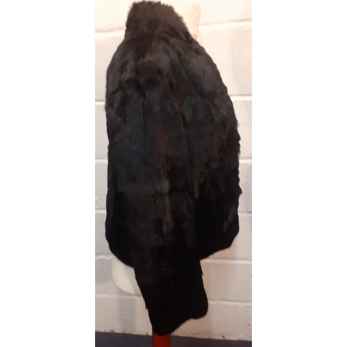 78 - Two fur jackets comprising a late 20th Century black coney soft fur jacket with shawl collar, UK siz... 