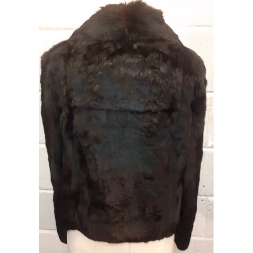 78 - Two fur jackets comprising a late 20th Century black coney soft fur jacket with shawl collar, UK siz... 