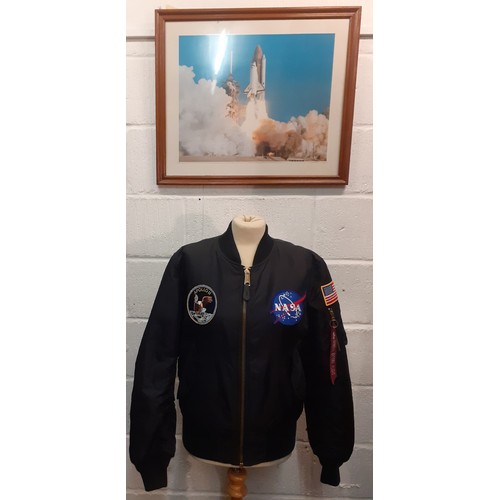 79 - An Alpha Industries black nylon Nasa Apollo II bomber jacket with embroidered fabric badges to front... 