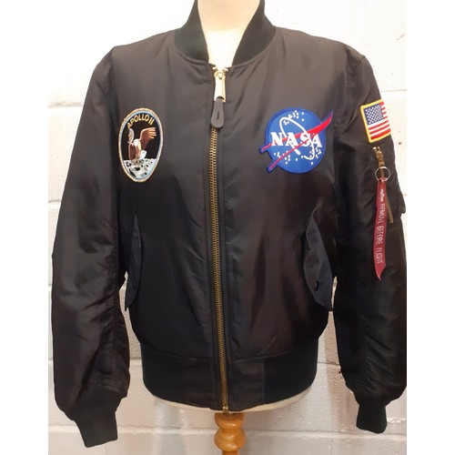 79 - An Alpha Industries black nylon Nasa Apollo II bomber jacket with embroidered fabric badges to front... 