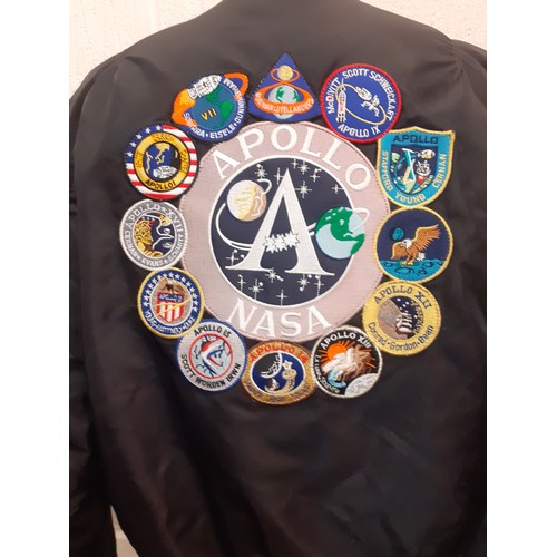 79 - An Alpha Industries black nylon Nasa Apollo II bomber jacket with embroidered fabric badges to front... 