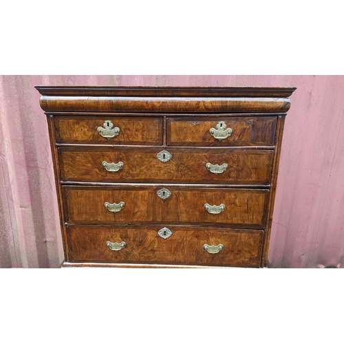 145 - An early 18th century walnut chest on stand having a moulded cornice, cushion moulded drawer, eight ... 