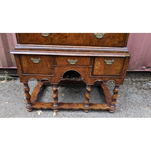 145 - An early 18th century walnut chest on stand having a moulded cornice, cushion moulded drawer, eight ... 