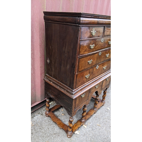 145 - An early 18th century walnut chest on stand having a moulded cornice, cushion moulded drawer, eight ... 