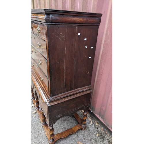 145 - An early 18th century walnut chest on stand having a moulded cornice, cushion moulded drawer, eight ... 