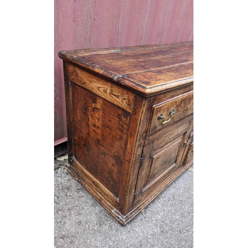 147 - An 18th century vernacular fruitwood sideboard, having three central drawers flanked by two further ... 