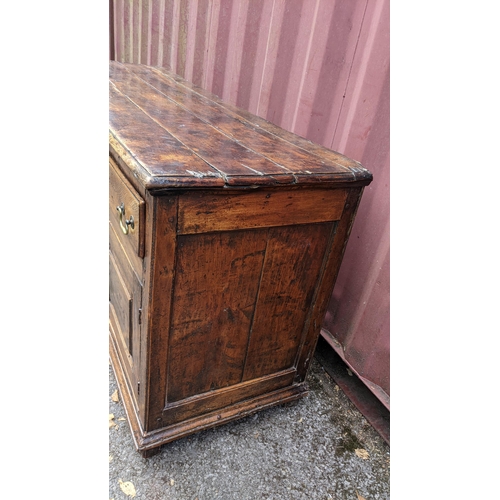 147 - An 18th century vernacular fruitwood sideboard, having three central drawers flanked by two further ... 