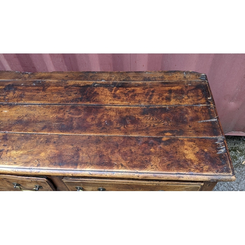 147 - An 18th century vernacular fruitwood sideboard, having three central drawers flanked by two further ... 