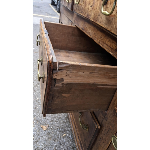 147 - An 18th century vernacular fruitwood sideboard, having three central drawers flanked by two further ... 