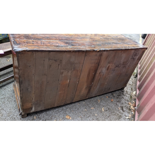 147 - An 18th century vernacular fruitwood sideboard, having three central drawers flanked by two further ... 