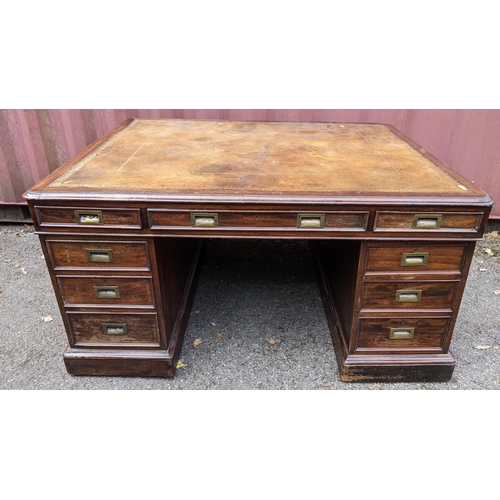 149 - A Victorian mahogany partners desk, having a leather topped scriber, above pedestals with eight frie... 