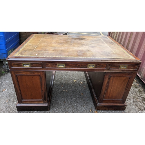 149 - A Victorian mahogany partners desk, having a leather topped scriber, above pedestals with eight frie... 