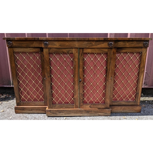 164 - A Regency rosewood breakfront sideboard, having four cupboard doors opening to reveal shelves, with ... 