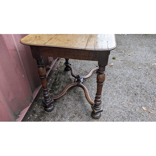 165 - A circa 1700 walnut side table, having a single frieze drawer, four baluster and knop turned legs un... 