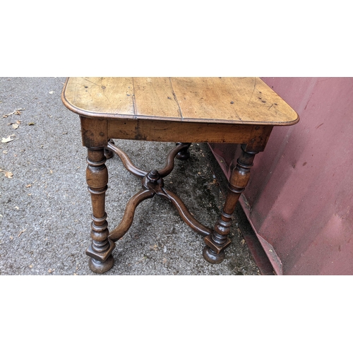 165 - A circa 1700 walnut side table, having a single frieze drawer, four baluster and knop turned legs un... 