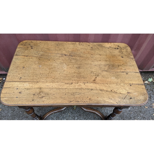 165 - A circa 1700 walnut side table, having a single frieze drawer, four baluster and knop turned legs un... 