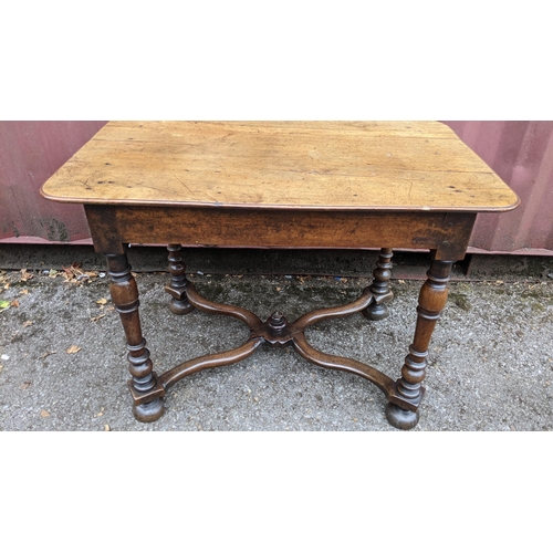 165 - A circa 1700 walnut side table, having a single frieze drawer, four baluster and knop turned legs un... 