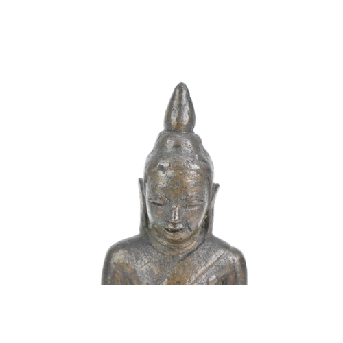 85 - A Thai, Lanna style bronze figure of Buddha Shakyamuni seated in virasana on a shaped base, his righ... 