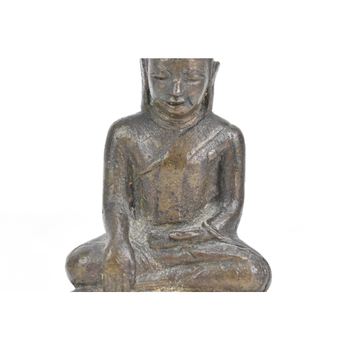 85 - A Thai, Lanna style bronze figure of Buddha Shakyamuni seated in virasana on a shaped base, his righ... 