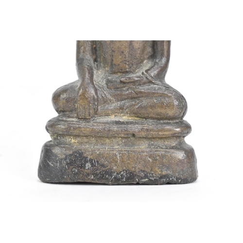 85 - A Thai, Lanna style bronze figure of Buddha Shakyamuni seated in virasana on a shaped base, his righ... 