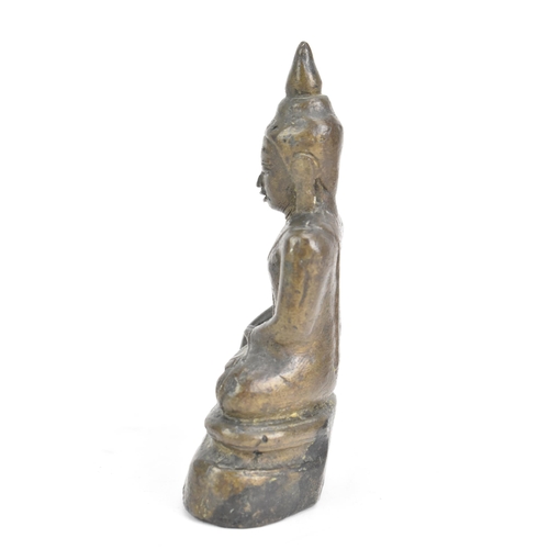 85 - A Thai, Lanna style bronze figure of Buddha Shakyamuni seated in virasana on a shaped base, his righ... 