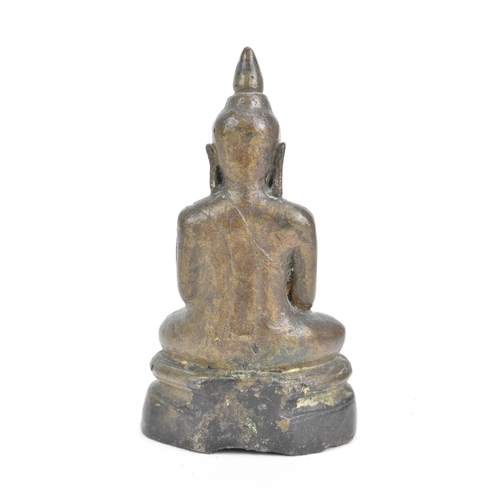 85 - A Thai, Lanna style bronze figure of Buddha Shakyamuni seated in virasana on a shaped base, his righ... 