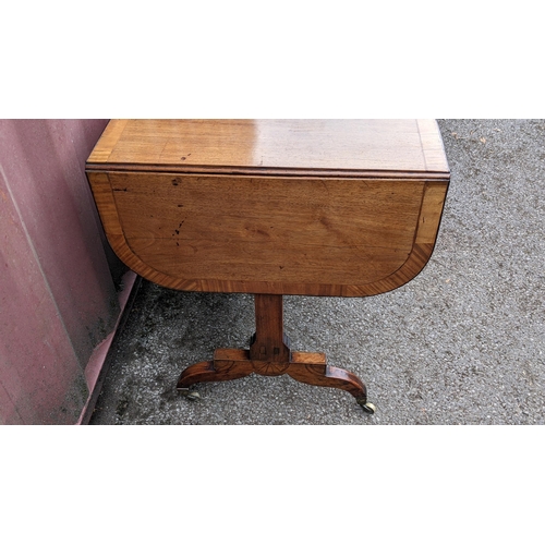 146 - A Regency mahogany sofa table, having a crossbanded rectangular top and two fall flaps, two frieze d... 