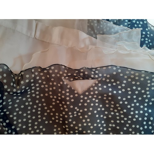 6 - Hardy Amies- A navy full length gown with white polka dot design throughout, having a double full le... 