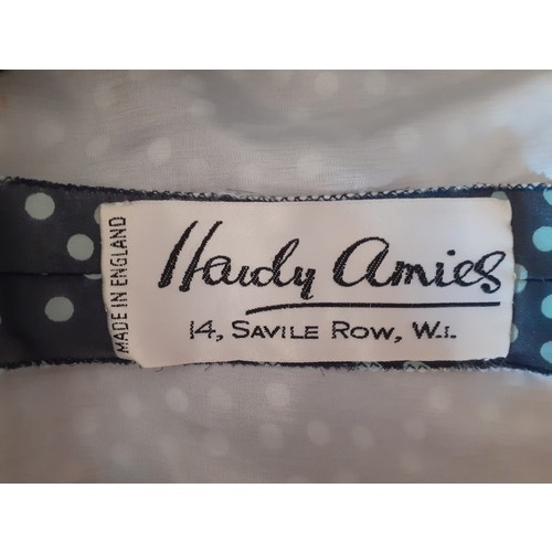 6 - Hardy Amies- A navy full length gown with white polka dot design throughout, having a double full le... 