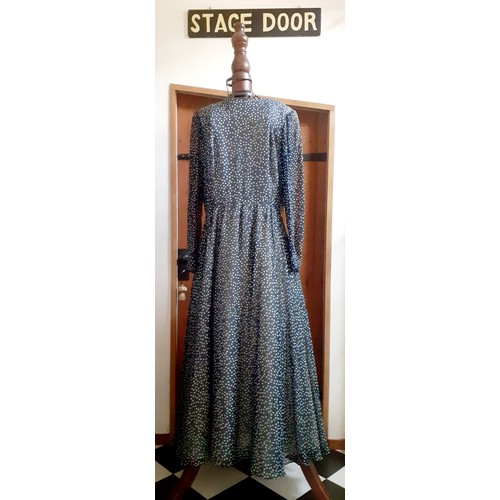 6 - Hardy Amies- A navy full length gown with white polka dot design throughout, having a double full le... 